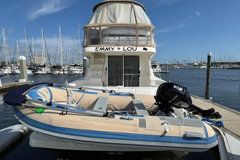 Slide: The Image of 2006 Sea Ray 44 Sedan Bridge yacht docked with inflatable boat, marina background. - 4