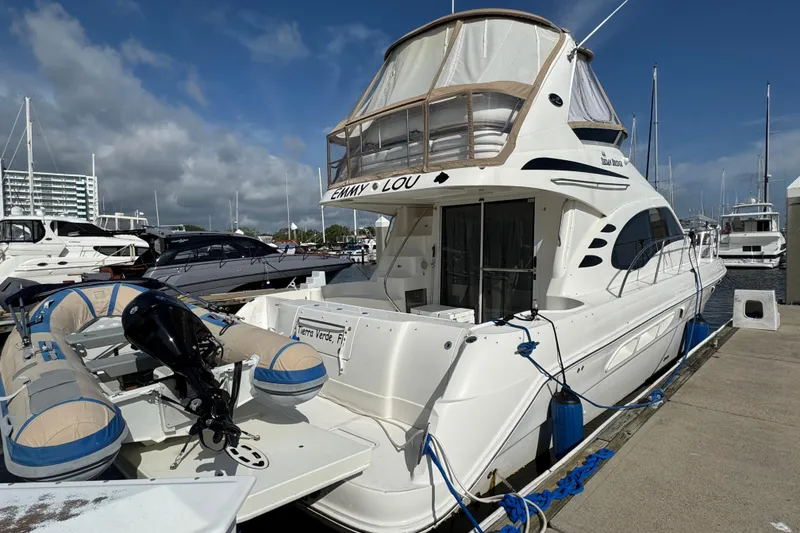 Slide: The Image of 2006 Sea Ray 44 Sedan Bridge yacht docked at marina under blue sky. - 5