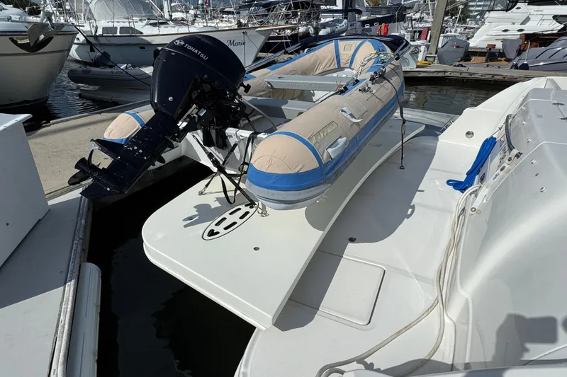 Slide: The Image of 2006 Sea Ray 44 Sedan Bridge with inflatable boat and Tohatsu motor at marina. - 6