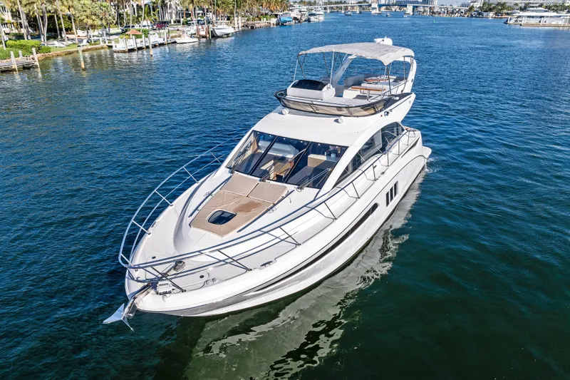 Slide: The Image of 2014 Sea Ray 510 Fly yacht cruising on a sunny day in a marina. - 11