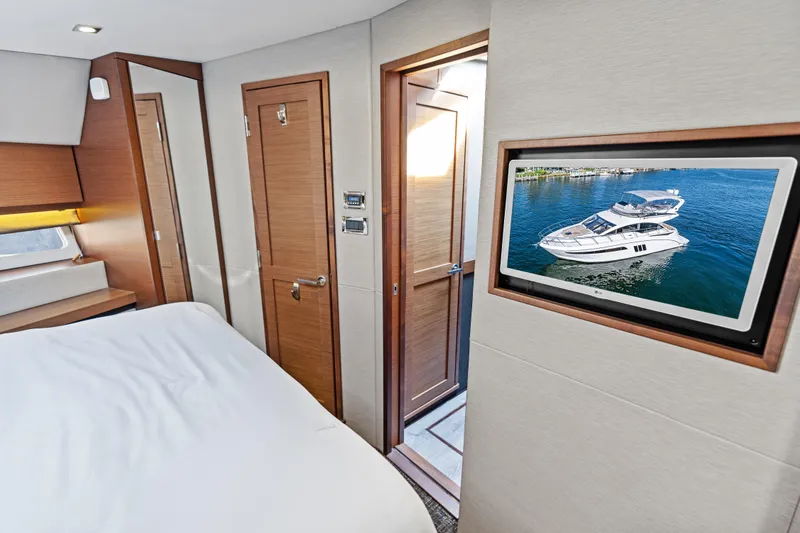 Slide: The Image of Interior of 2014 Sea Ray 510 Fly yacht with TV displaying exterior view. - 37