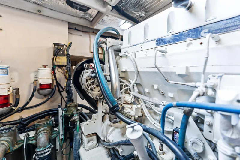 Slide: The Image of Engine room of 2014 Sea Ray 510 Fly yacht, showcasing complex machinery and wiring. - 48
