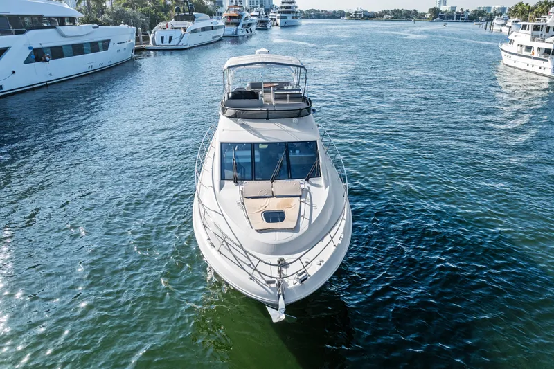 Slide: The Image of 2014 Sea Ray 510 Fly yacht cruising in a scenic marina setting. - 9