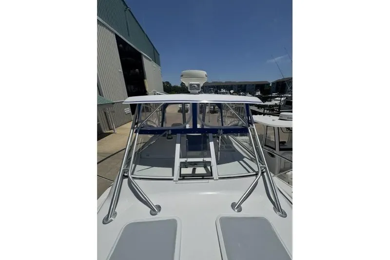 Slide: The Image of 2005 Pro-Line 32 Express boat docked, showcasing sleek design and sturdy construction. - 13