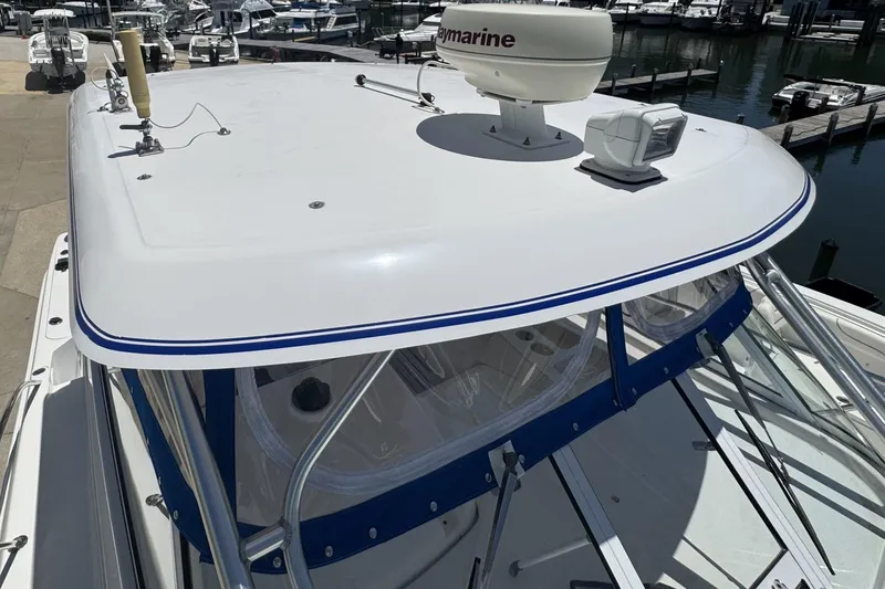 Slide: The Image of 2005 Pro-Line 32 Express boat with radar and navigation equipment at a marina. - 14