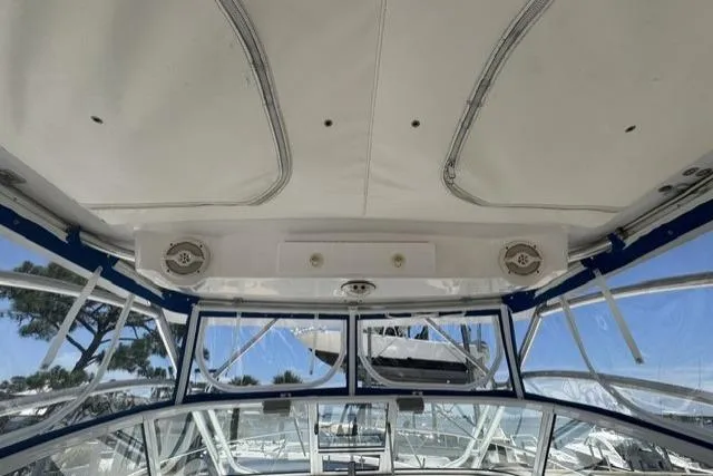 Slide: The Image of 2005 Pro-Line 32 Express boat interior with clear canopy and speaker system. - 16
