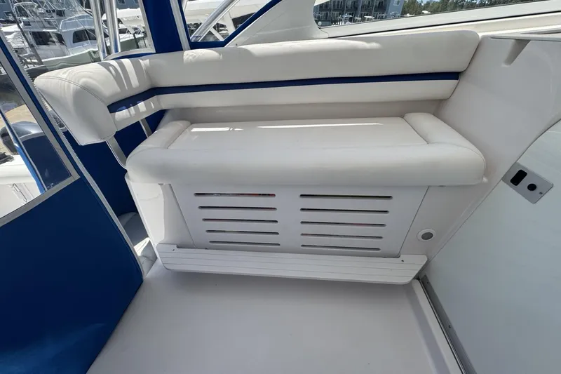 Slide: The Image of 2005 Pro-Line 32 Express boat interior with white cushioned seating and blue accents. - 17