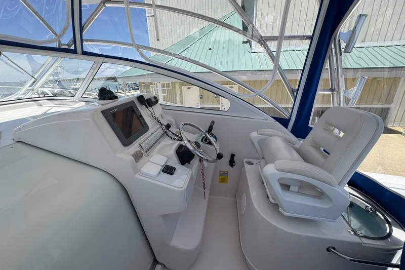 Slide: The Image of 2005 Pro-Line 32 Express helm with steering wheel, navigation equipment, and comfortable seating. - 19