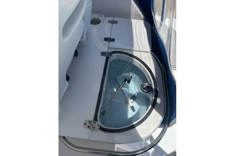 Slide: The Image of Livewell on 2005 Pro-Line 32 Express boat, featuring a clear lid and stainless steel hardware. - 21