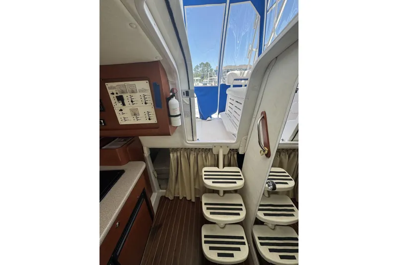 Slide: The Image of Interior view of 2005 Pro-Line 32 Express boat, featuring steps and control panel. - 22