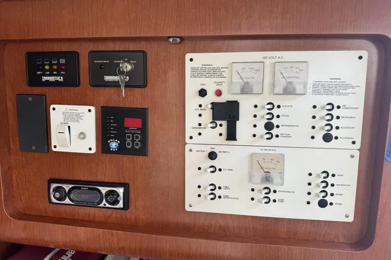 Slide: The Image of Electrical control panel of a 2005 Pro-Line 32 Express boat, featuring various switches and gauges. - 25