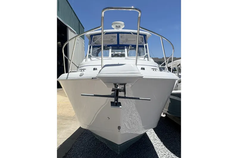 Slide: The Image of 2005 Pro-Line 32 Express boat, front view, docked outdoors under clear blue sky. - 3