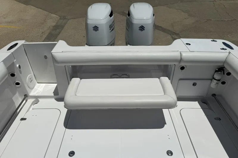 Slide: The Image of 2005 Pro-Line 32 Express boat deck with seating and dual Suzuki outboard motors. - 7