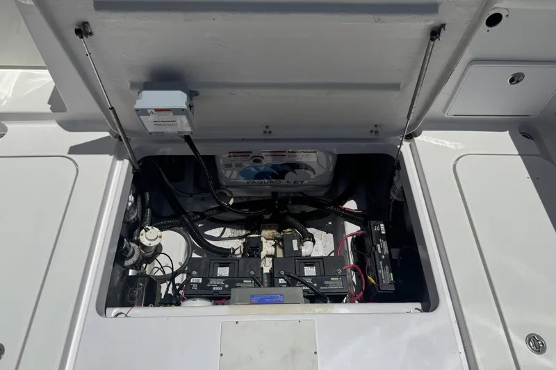 Slide: The Image of Open engine compartment of 2005 Pro-Line 32 Express boat, showing batteries and wiring. - 9