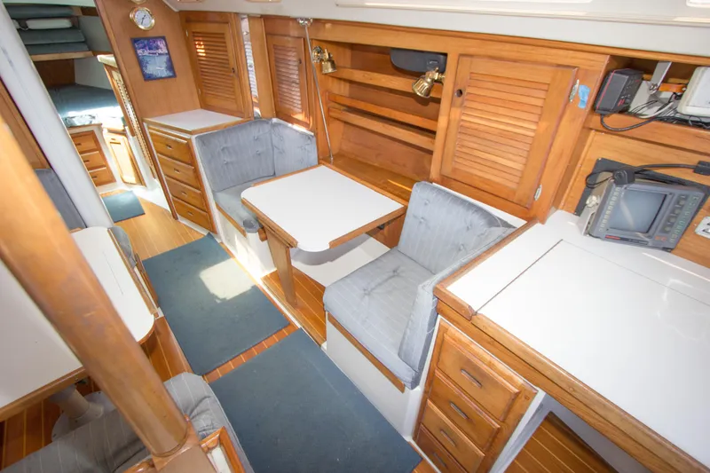 Slide: The Image of Interior of a 1991 Catalina 36 sailboat with wooden cabinetry and seating area. - 11