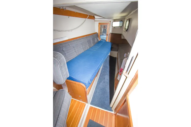 Slide: The Image of Interior of a 1991 Catalina 36 sailboat with blue and gray seating. - 15