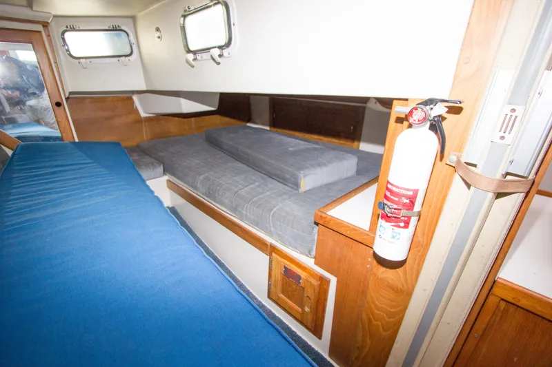 Slide: The Image of Interior cabin of a 1991 Catalina 36 sailboat with blue and gray cushions. - 16