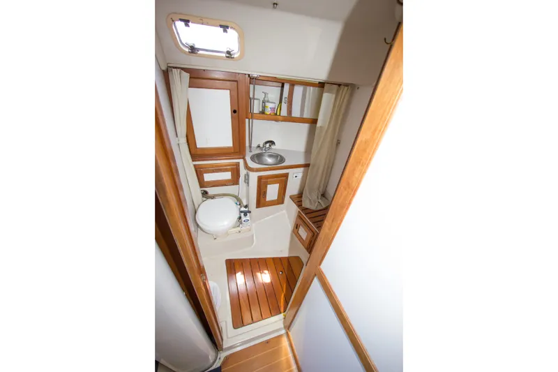 Slide: The Image of 1991 Catalina 36 yacht bathroom with wooden accents and compact design. - 17