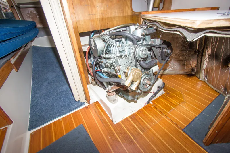 Slide: The Image of Engine compartment of a 1991 Catalina 36 sailboat, showcasing detailed mechanical components. - 19