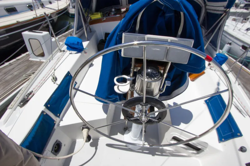 Slide: The Image of Cockpit view of a 1991 Catalina 36 sailboat with steering wheel and navigation instruments. - 23
