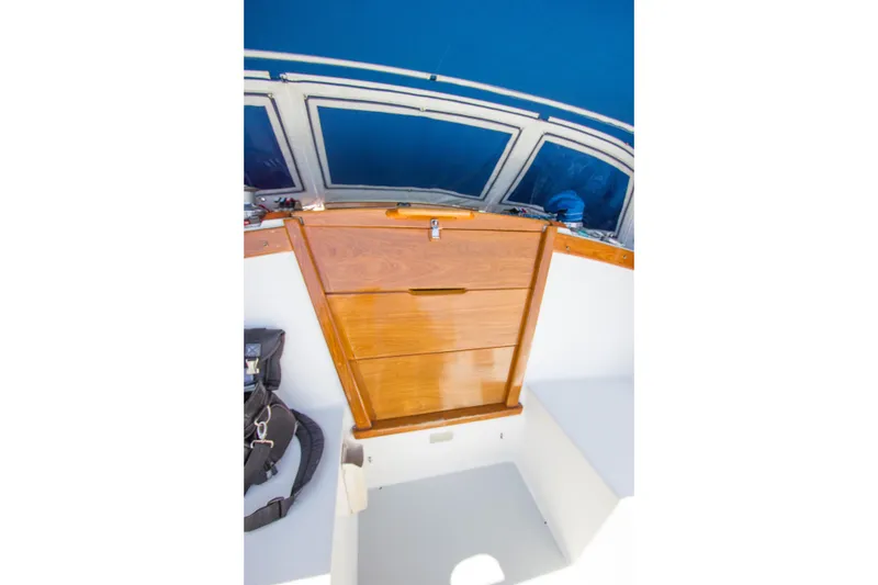 Slide: The Image of Wooden hatch on 1991 Catalina 36 sailboat, with blue canopy and windows. - 24