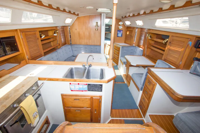 Slide: The Image of Interior of a 1991 Catalina 36 sailboat with wood finishes and cozy seating. - 6