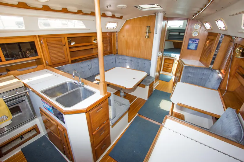 Slide: The Image of Interior of a 1991 Catalina 36 sailboat with kitchen and seating area. - 7