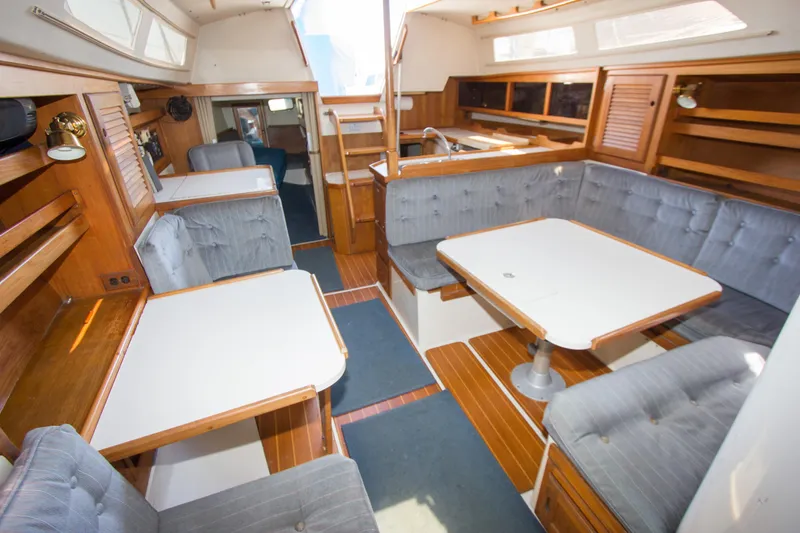 Slide: The Image of Interior of a 1991 Catalina 36 sailboat with cozy seating and wooden accents. - 8