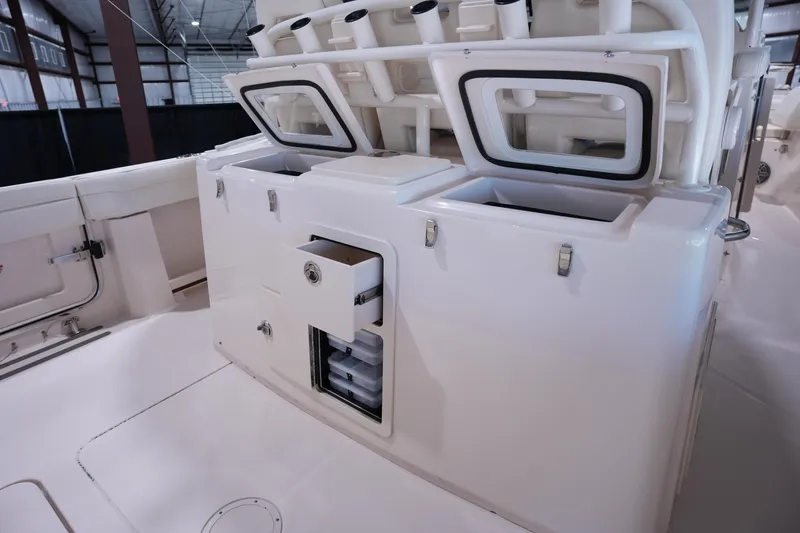 Slide: The Image of 2023 Grady-White Canyon 336 boat interior with storage compartments and rod holders. - 10