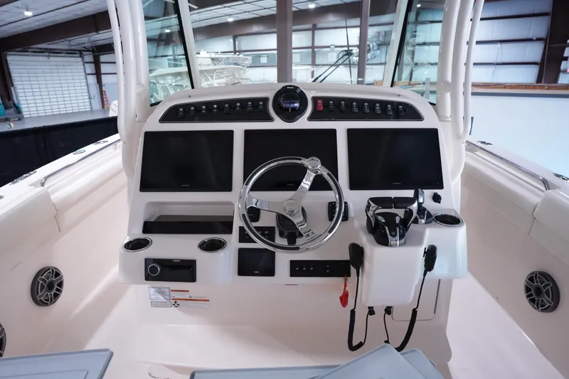 Slide: The Image of 2023 Grady-White Canyon 336 boat helm with modern controls and dual displays. - 15