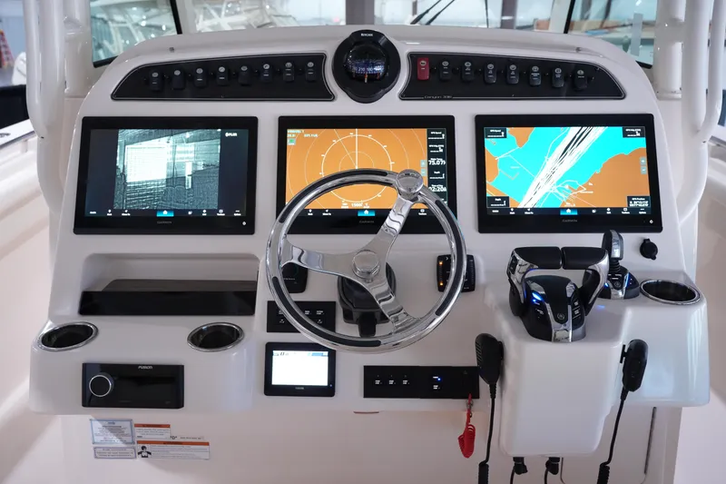 Slide: The Image of 2023 Grady-White Canyon 336 helm with advanced navigation displays and controls. - 17