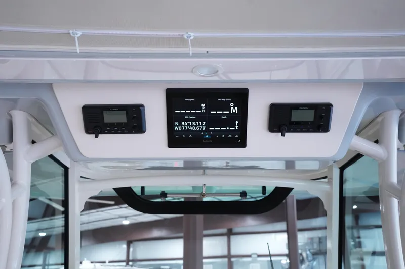 Slide: The Image of 2023 Grady-White Canyon 336 dashboard with GPS and communication systems. - 18