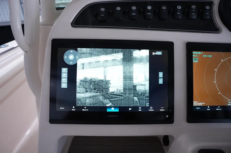 Slide: The Image of 2023 Grady-White Canyon 336 boat dashboard with Garmin navigation displays. - 19