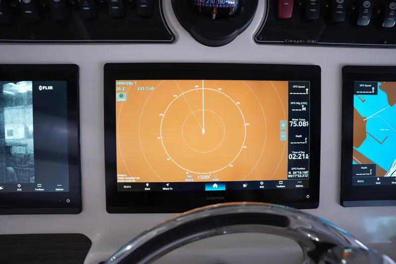 Slide: The Image of 2023 Grady-White Canyon 336 boat dashboard with Garmin navigation displays. - 20