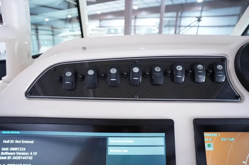 Slide: The Image of Control panel of 2023 Grady-White Canyon 336 boat with switches and display screens. - 32