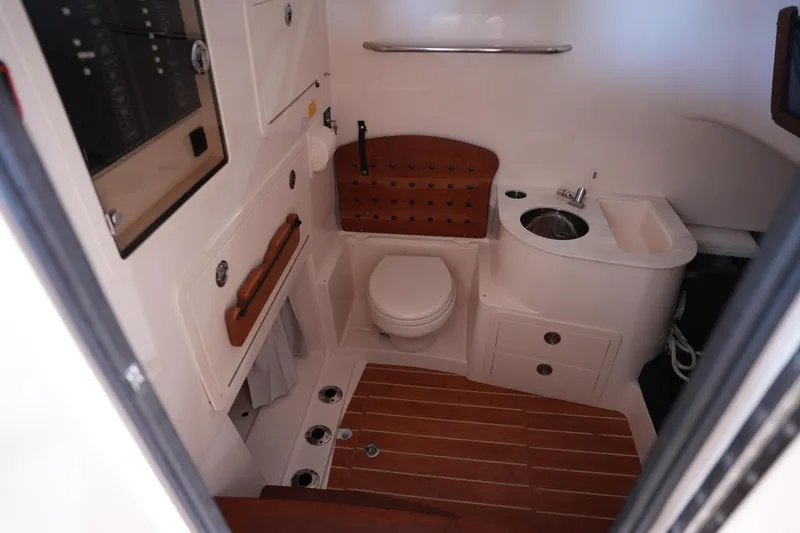 Slide: The Image of 2023 Grady-White Canyon 336 boat interior with compact bathroom amenities. - 33