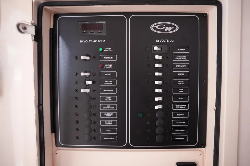 Slide: The Image of Electrical control panel on 2023 Grady-White Canyon 336 boat, featuring AC and DC switches. - 34