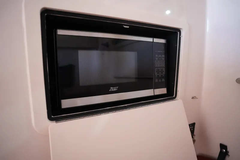 Slide: The Image of Built-in microwave in 2023 Grady-White Canyon 336 boat interior. - 35