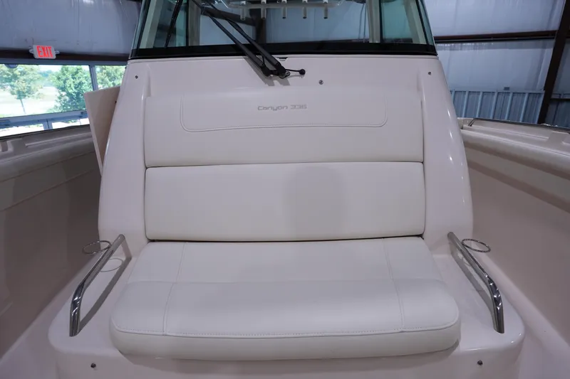 Slide: The Image of 2023 Grady-White Canyon 336 boat interior with white cushioned seating. - 39