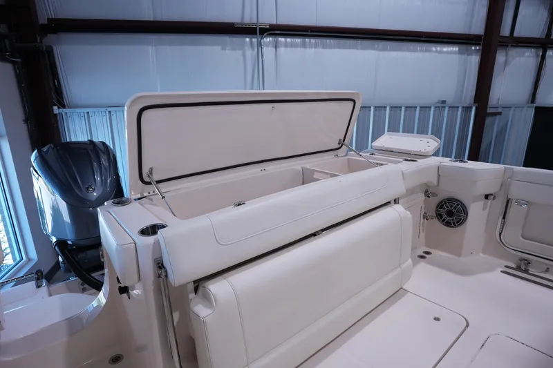 Slide: The Image of 2023 Grady-White Canyon 336 boat interior with open storage compartment and seating. - 4