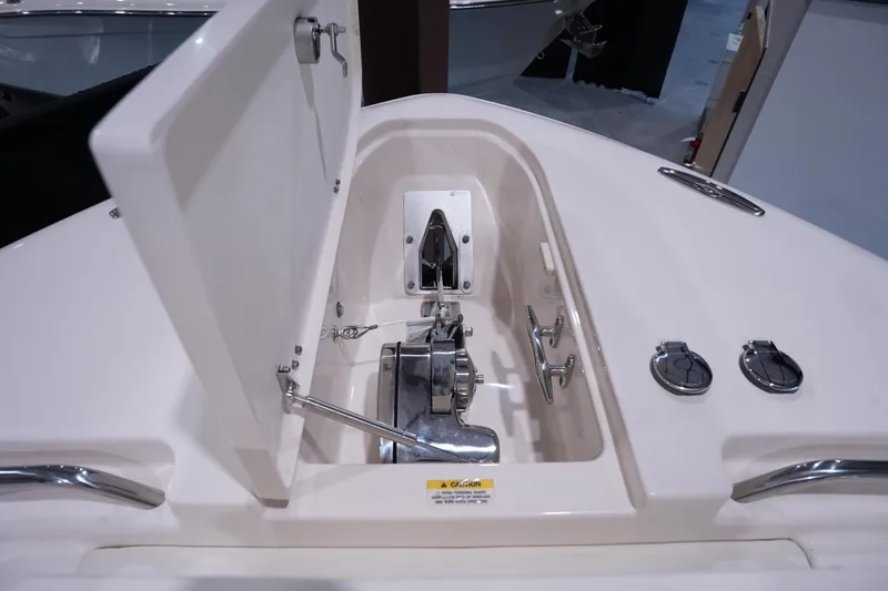 Slide: The Image of 2023 Grady-White Canyon 336 anchor compartment with open hatch and cleats. - 43