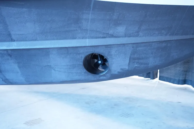 Slide: The Image of 2023 Grady-White Canyon 336 boat hull with visible thruster detail. - 44