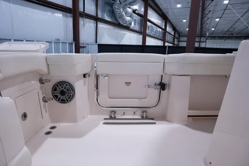 Slide: The Image of 2023 Grady-White Canyon 336 boat interior with seating and speaker in a showroom. - 6