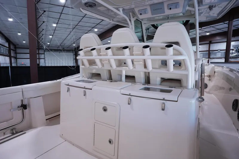 Slide: The Image of 2023 Grady-White Canyon 336 boat interior with rod holders and storage compartments. - 8