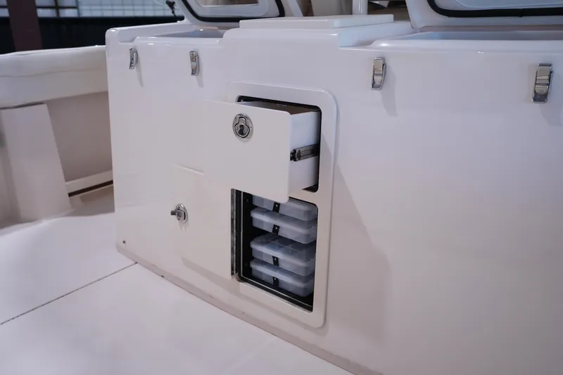 Slide: The Image of 2023 Grady-White Canyon 336 boat storage compartment with organized tackle boxes. - 9