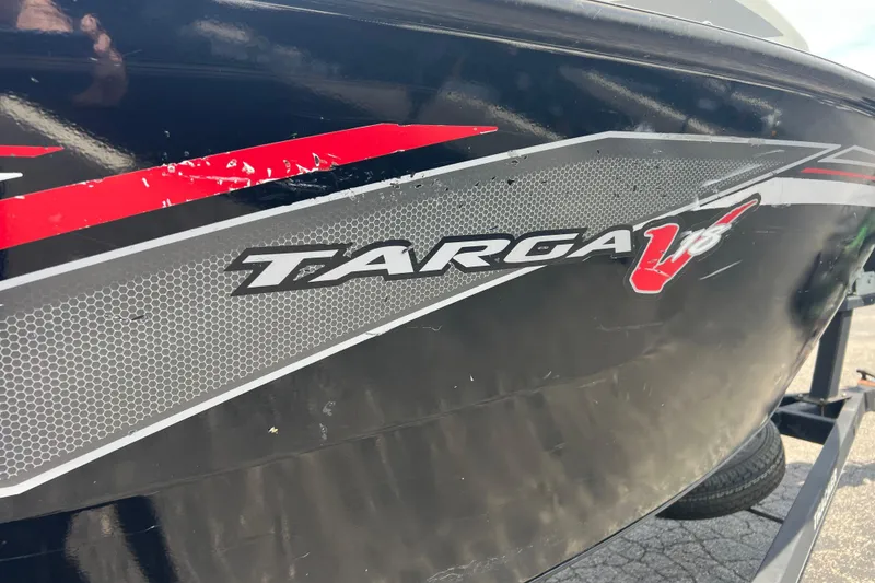 Slide: The Image of 2017 Tracker Targa V-18 WT boat with red and gray graphics on the side. - 6