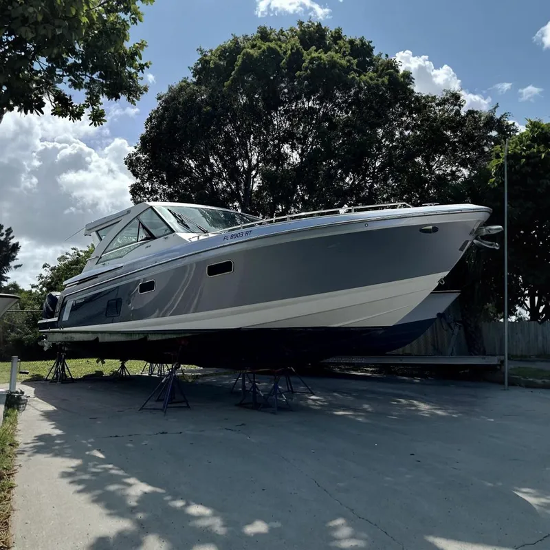 The Image of 2018 Formula 430 Super Sport Crossover boat on stands outdoors. - 0