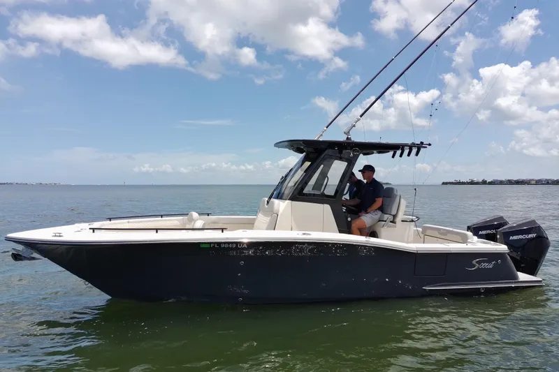 The Image of 2026 Scout 260 LXF boat on water, featuring sleek design and dual Mercury engines. - 0
