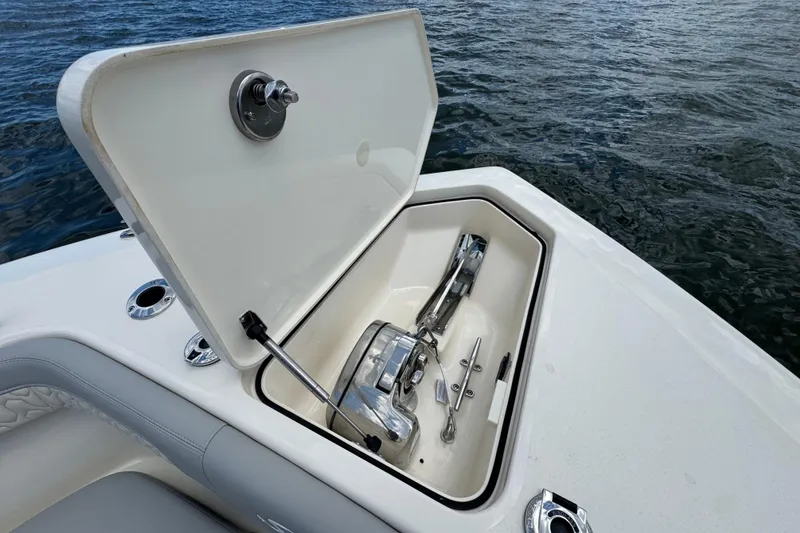 Slide: The Image of Open anchor compartment on 2026 Scout 260 LXF boat, showing anchor and mechanism. - 10