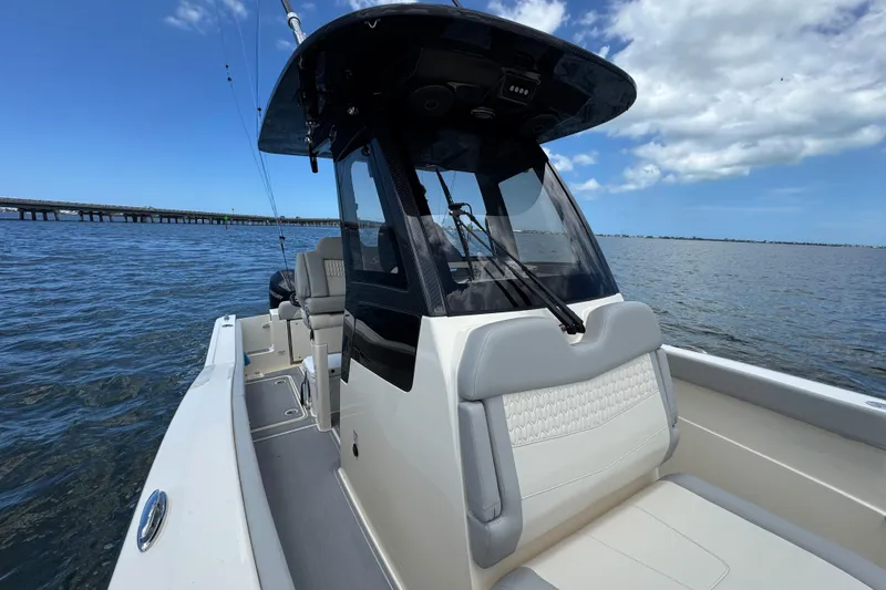 Slide: The Image of 2026 Scout 260 LXF boat on water, featuring sleek design and comfortable seating. - 12